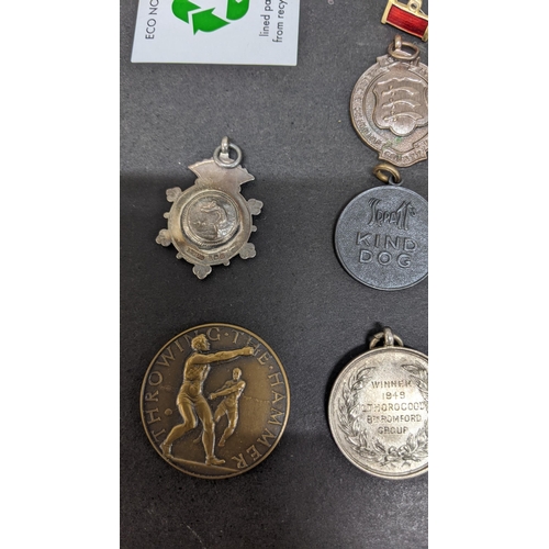 409 - **THIS LOT HAS BEEN WITHDRAWN**
Mixed medals and badges to include an Elizabeth II naval general ser... 