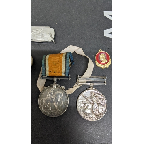 409 - **THIS LOT HAS BEEN WITHDRAWN**
Mixed medals and badges to include an Elizabeth II naval general ser... 