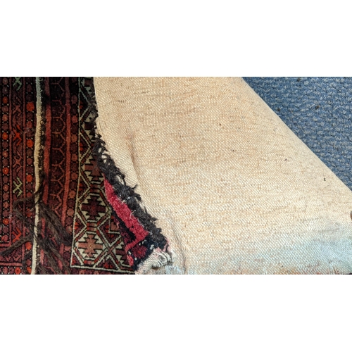 460 - A Persian saddle bag rug having geometric motifs on a red ground 49cm w x 125cm l
Location:G