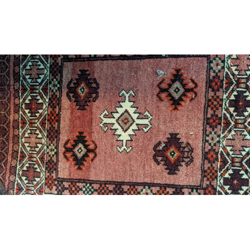 460 - A Persian saddle bag rug having geometric motifs on a red ground 49cm w x 125cm l
Location:G