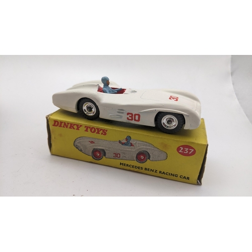 Three Dinky toys to include a boxed Mercedes Benz racing car 237 with a white body light blue dri