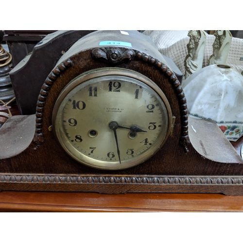 106 - A mixed lot to include a plated drinks dispenser stand, two mantel clocks, a barley twist table lamp... 