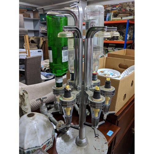 106 - A mixed lot to include a plated drinks dispenser stand, two mantel clocks, a barley twist table lamp... 