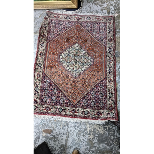 105 - A Persian Bijar hand woven rug having a red ground, 160cm x 116cmLocation:G