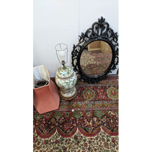 110 - A late 20th century Chinese table lamp with a shade and a black plastic framed mirror
Location:G