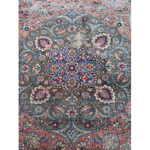 109 - A Persian Tabriz carpet, handwoven, floral pattern on a red ground, triple guard border and tasselle... 