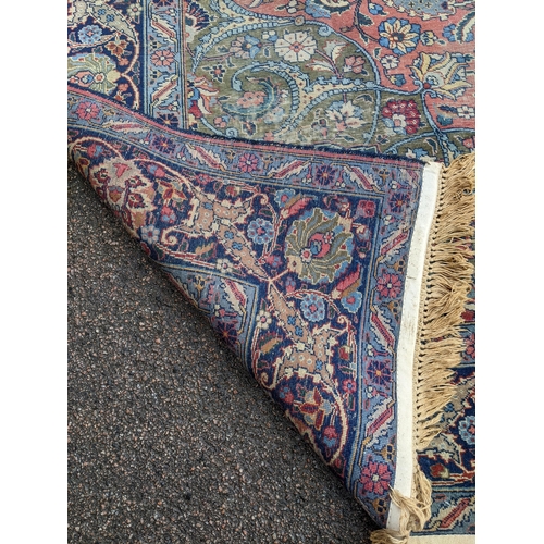 109 - A Persian Tabriz carpet, handwoven, floral pattern on a red ground, triple guard border and tasselle... 