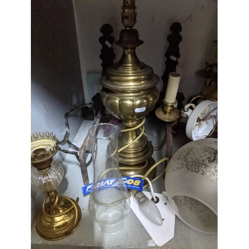 111 - A selection of lighting to include brass effect chandeliers porch and storm lanterns, some with glas... 