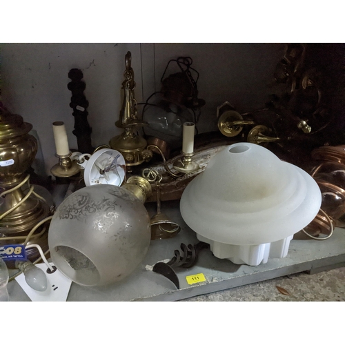 111 - A selection of lighting to include brass effect chandeliers porch and storm lanterns, some with glas... 
