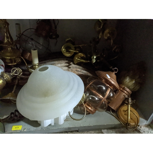 111 - A selection of lighting to include brass effect chandeliers porch and storm lanterns, some with glas... 