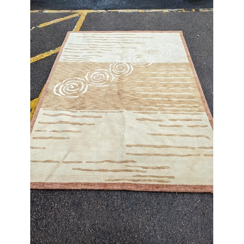 112 - A contemporary cream and beige rug with swirl and line decoration 242cm x 175cm Location:A3B