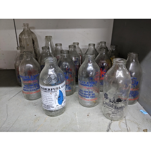 69 - A group of vintage glass milk bottles, some from local dairies, to include Stokes Dairy Camberley an... 