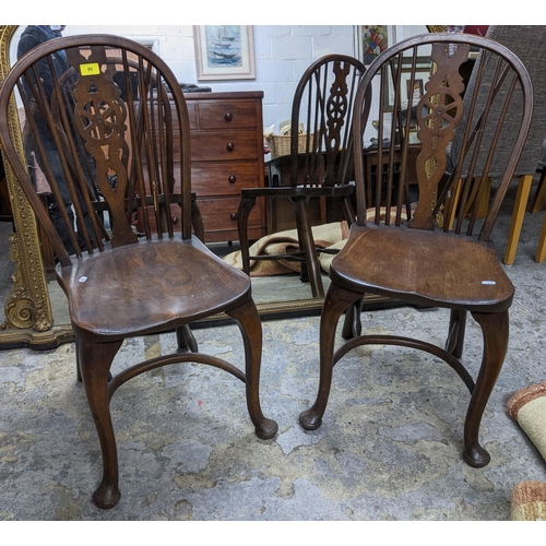 96 - Two 20th century elm seated Windsor wheel back chairs with crinoline elliptical and stretchers, cabr... 