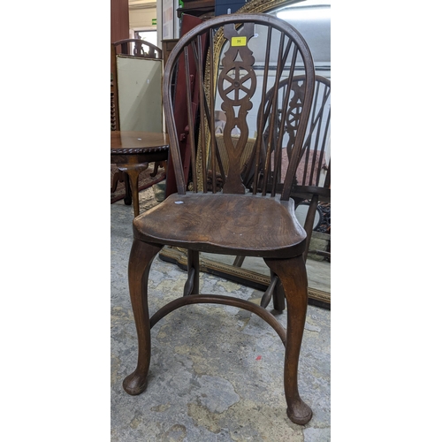 96 - Two 20th century elm seated Windsor wheel back chairs with crinoline elliptical and stretchers, cabr... 