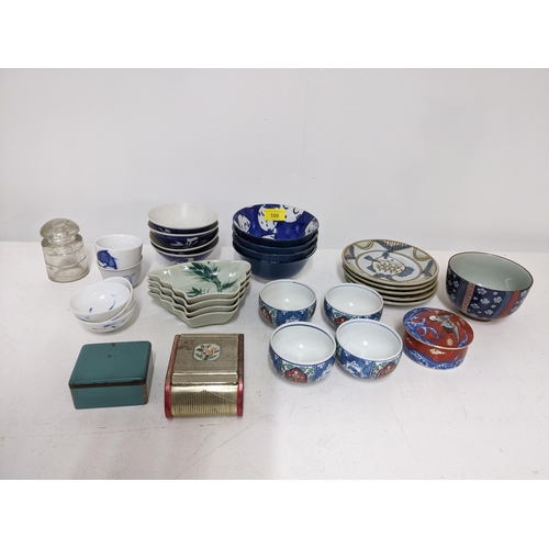 99 - A basket of Masons Regency/Colonial table ceramics to include three jugs, octagonal bowl, meat plate... 