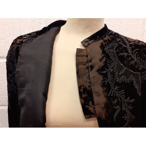 89 - A late 19th Century Madame Garnier et Cie black velvet cape A/F with black beadwork design and pocke... 