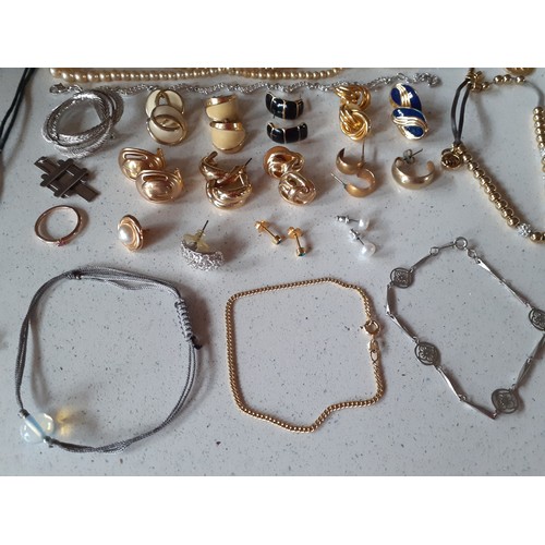 95 - A quantity of mainly modern costume jewellery to include silver tone Swarovski crystal pendants on c... 