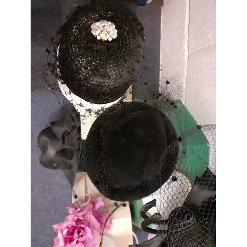 93 - A quantity of 20th Century hats comprising a Philip Somerville black silk hat with net and bow detai... 