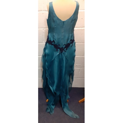 92 - A 2000's Wim Hemmink teal silk sleeveless evening gown, UK size 14, having navy lace applique to the... 