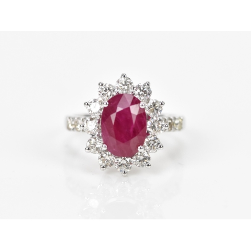 154 - An 18ct white gold, diamond and ruby dress ring, set with central oval mixed cut ruby in four claw s... 