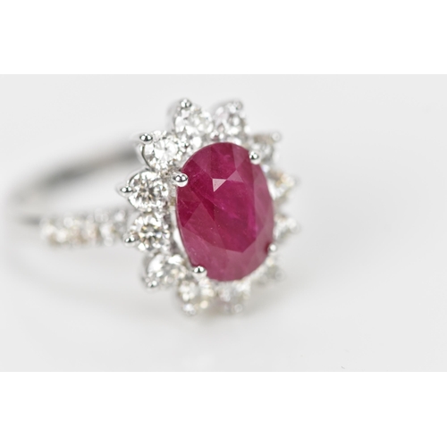 154 - An 18ct white gold, diamond and ruby dress ring, set with central oval mixed cut ruby in four claw s... 