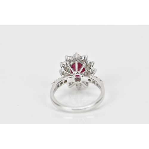 154 - An 18ct white gold, diamond and ruby dress ring, set with central oval mixed cut ruby in four claw s... 