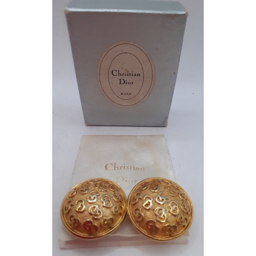 Christian Dior-A pair of monogrammed gold tone clip-on earrings in circular form with branded box. Location:Cab