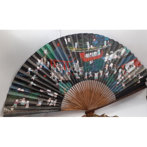 133 - Five early to mid 20th Century paper and fabric fans to include an Oriental black paper fan with pai... 