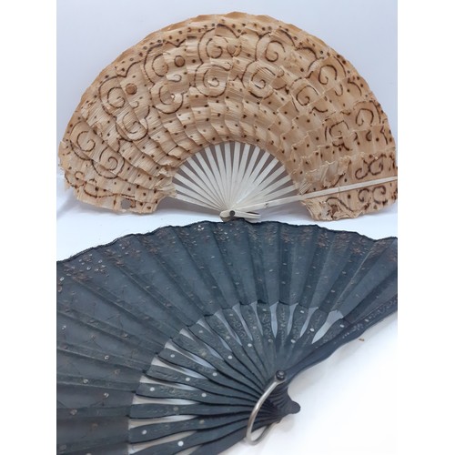 134 - Four fans comprising 19th Century bone wand and palmette style fan, a Victorian black fabric fan, a ... 