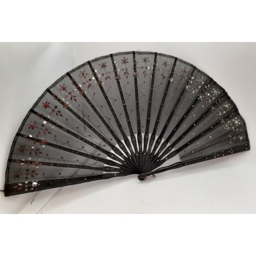 134 - Four fans comprising 19th Century bone wand and palmette style fan, a Victorian black fabric fan, a ... 