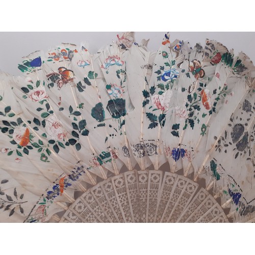 134 - Four fans comprising 19th Century bone wand and palmette style fan, a Victorian black fabric fan, a ... 