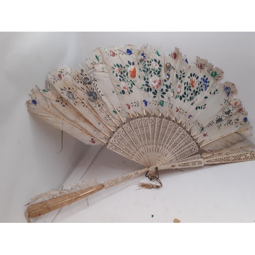 134 - Four fans comprising 19th Century bone wand and palmette style fan, a Victorian black fabric fan, a ... 