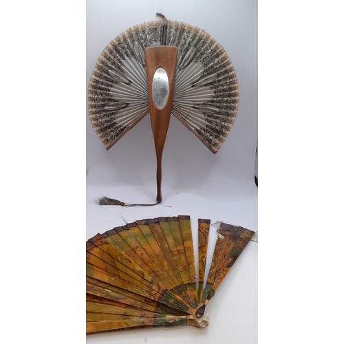 136 - Three Continental fans to include a Victorian treen and paper cockade fan with inset mirror. Locatio... 