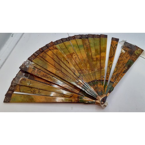 136 - Three Continental fans to include a Victorian treen and paper cockade fan with inset mirror. Locatio... 