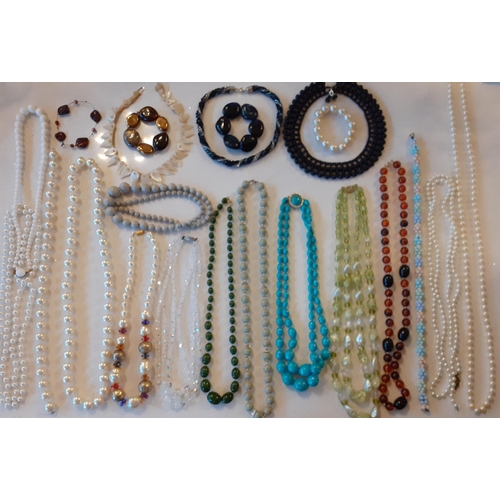 104 - A quantity of vintage costume jewellery, mainly bead necklaces to include a 3-strand Aurora Borealis... 