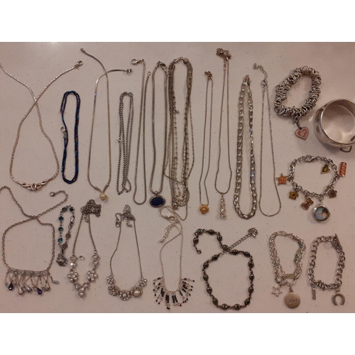 105 - A quantity of silver tone and white metal chains with costume pendants together with costume charm b... 