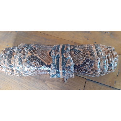 116 - A vintage snakeskin roll measuring 180