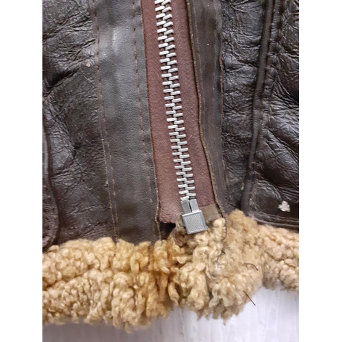 169 - A vintage leather flying jacket, no internal labels with blonde shearling lining, 46