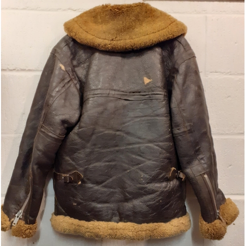 169 - A vintage leather flying jacket, no internal labels with blonde shearling lining, 46