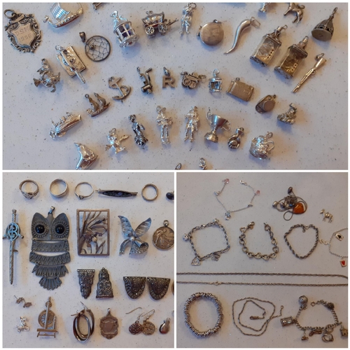 59 - A quantity of silver and white metal charms, vintage brooches to include one in the form of a sword,... 