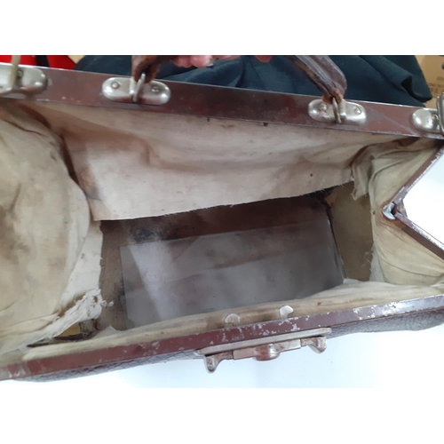 142 - An early 20th Century brown leather Gladstone bag A/F having a crocodile design with brushed silver ... 