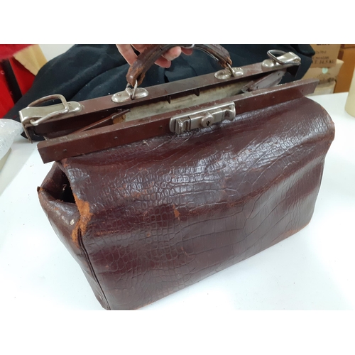 142 - An early 20th Century brown leather Gladstone bag A/F having a crocodile design with brushed silver ... 