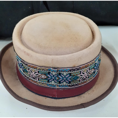 143 - A group of mainly mid 20th Century hats to include a tall domed brown felt bowler hat, size 56, a Sp... 