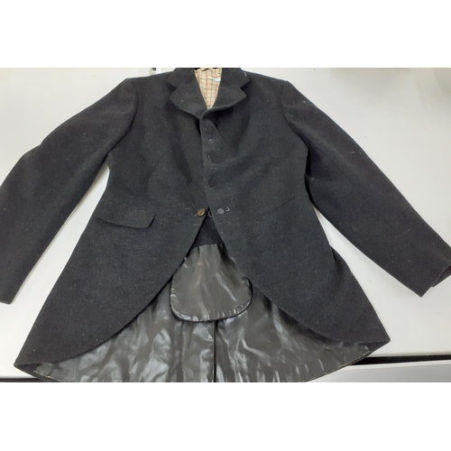 150 - A group of vintage clothing to include a dark grey woollen riding tail coat, 38