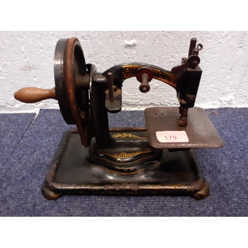 179 - A 19th Century cast iron hand cranked sewing machine with gilt decoration, rubber intact. Location:R... 