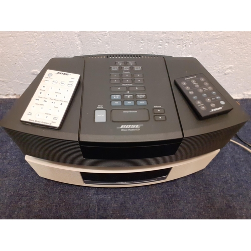 181 - A cream Bose CD player with remote together with a black Bose Wave radio/CD player with remote. Loca... 