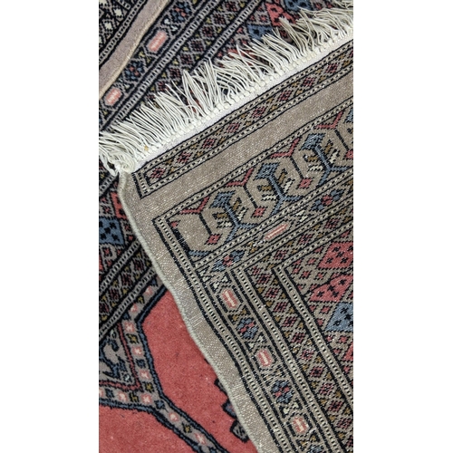 231 - A Pakistani hand woven runner with elephant foot motifs and tasselled ends, 190cm x 81.5cmw, togethe... 