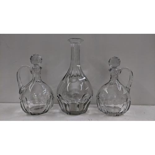 254 - Three Baccarat glass decanters including one with a tall reeded neck 35.5cm h, and a pair with handl... 