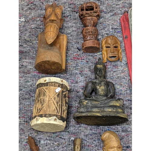 282 - A collection of African style wooden sculptures and figures to include a seated Buddha, a drum and o... 