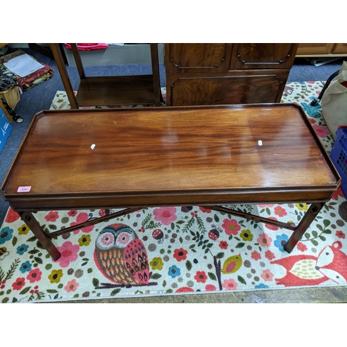 330 - A Mahogany coffee table with galleried top, c-scroll corner brackets, pierced cross stretchers, a ma... 